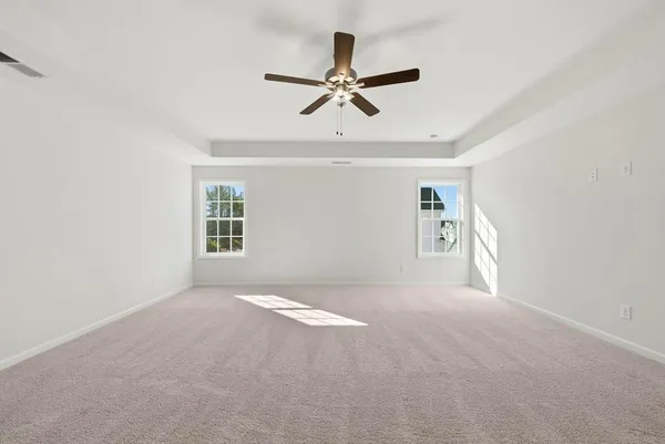 a view of a livingroom with a ceiling fan and window