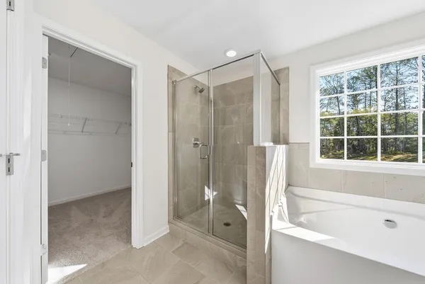 a bathroom with a bathtub shower and a sink