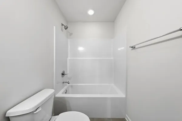 a bathroom with a toilet and a bath tub
