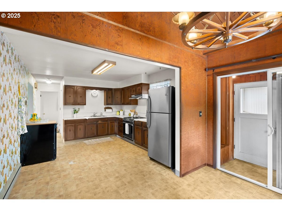 46389 Southwest Patton Valley Road Gaston, OR 97119 - Photo 10 of 48 a kitchen with stainless steel appliances kitchen island granite countertop a refrigerator and a sink