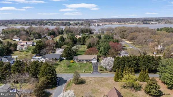 an aerial view of a houses with a yard