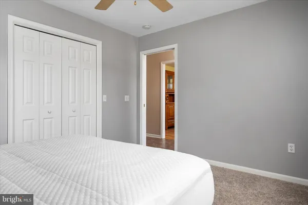 a spacious bedroom with a bed and window