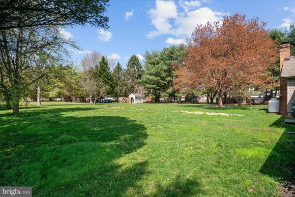 a front view of a house with yard and green space