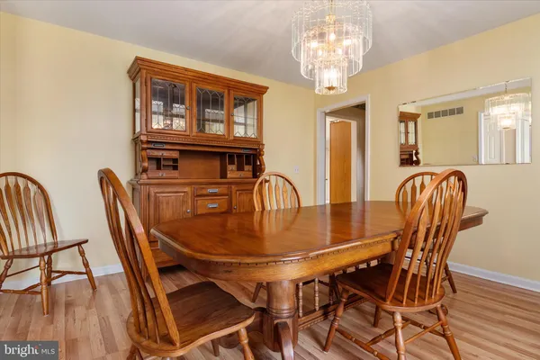 a view of a hallway with wooden floor and furniture