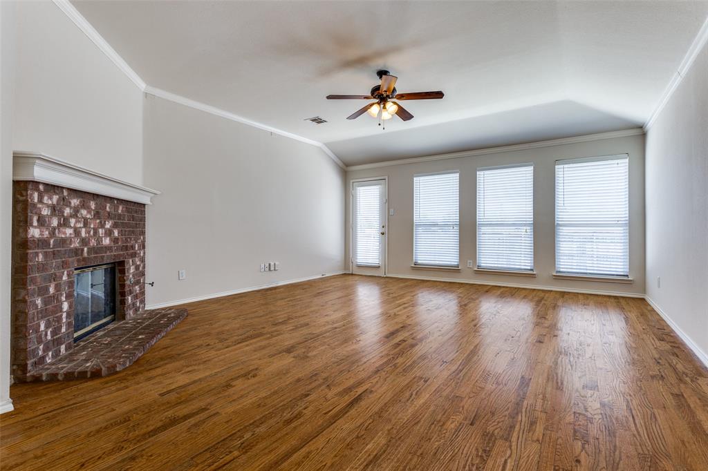 9710 Revolution Way Frisco, TX 75033 - Photo 18 of 25 a view of an empty room with wooden floor and a window