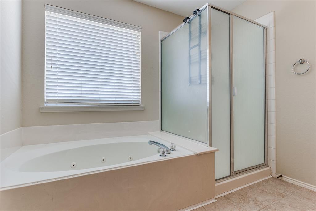 9710 Revolution Way Frisco, TX 75033 - Photo 20 of 25 a bathroom with a bathtub and a shower