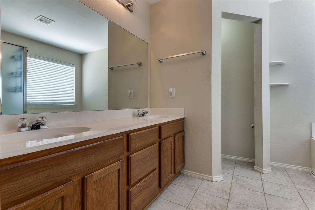 9710 Revolution Way Frisco, TX 75033 - Photo 5 of 25 a bathroom with a double vanity sink and a mirror
