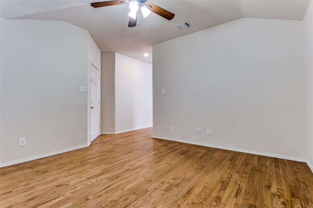 9710 Revolution Way Frisco, TX 75033 - Photo 9 of 25 wooden floor in an empty room with a chandelier fan
