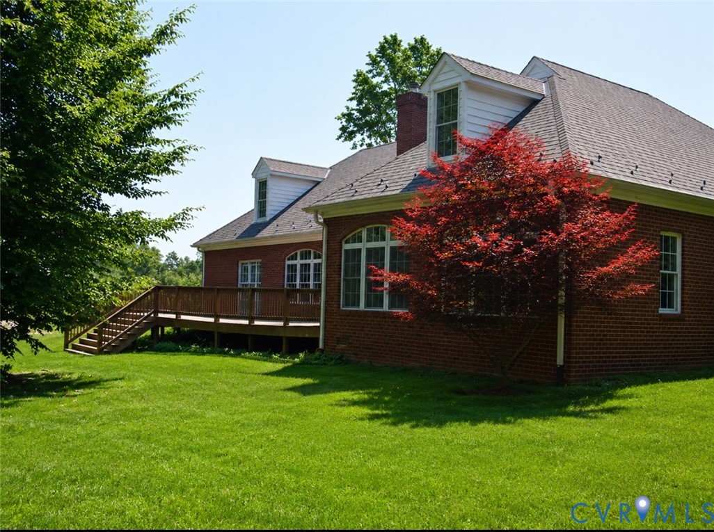 239 Jennings Road Cartersville, VA 23027 - Photo 4 of 26 Brick exterior featuring multiple dormer windows