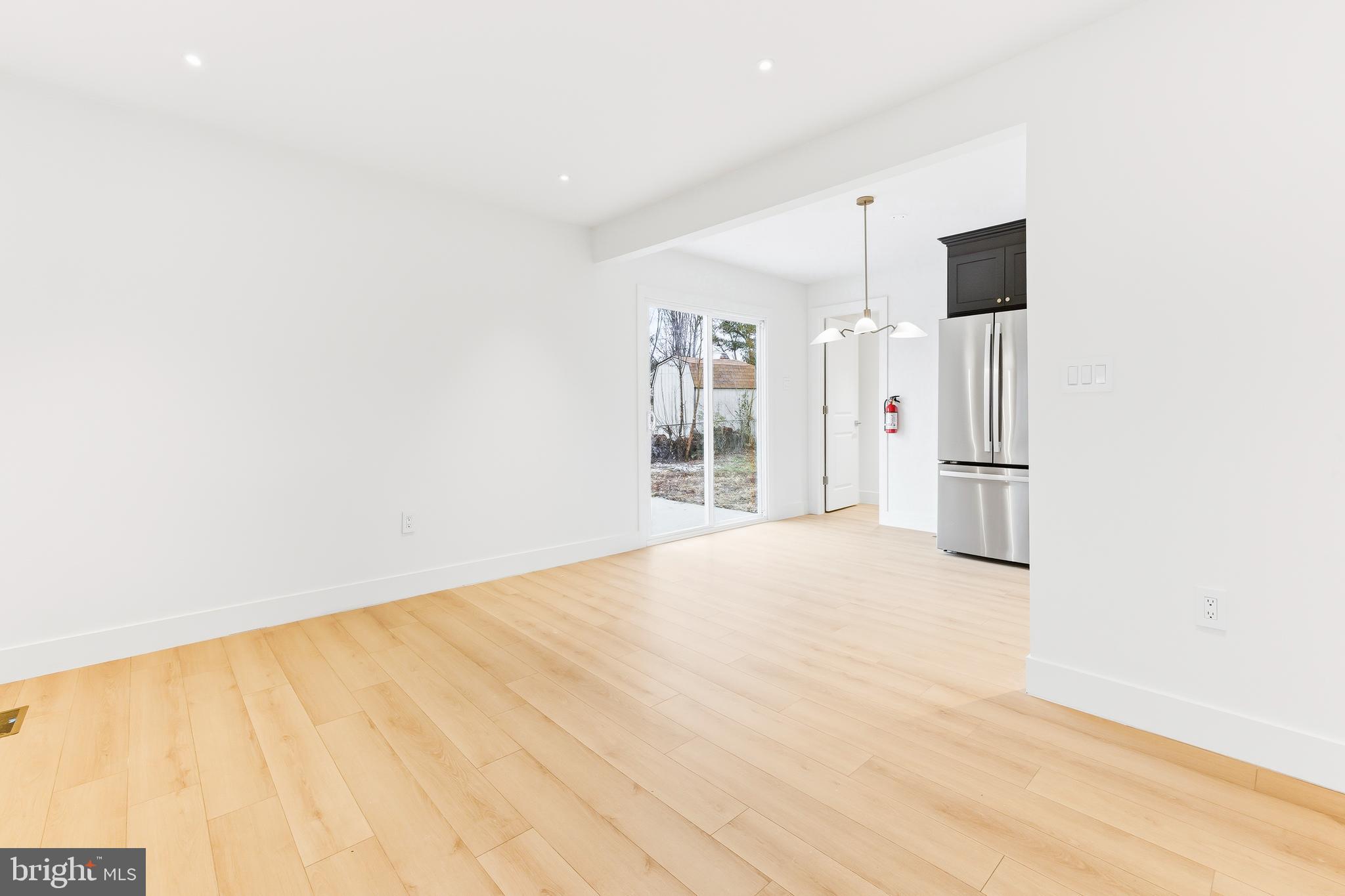 68 Craig Drive Deptford, NJ 08096 - Photo 3 of 20 a view of empty room with wooden floor and cabinet