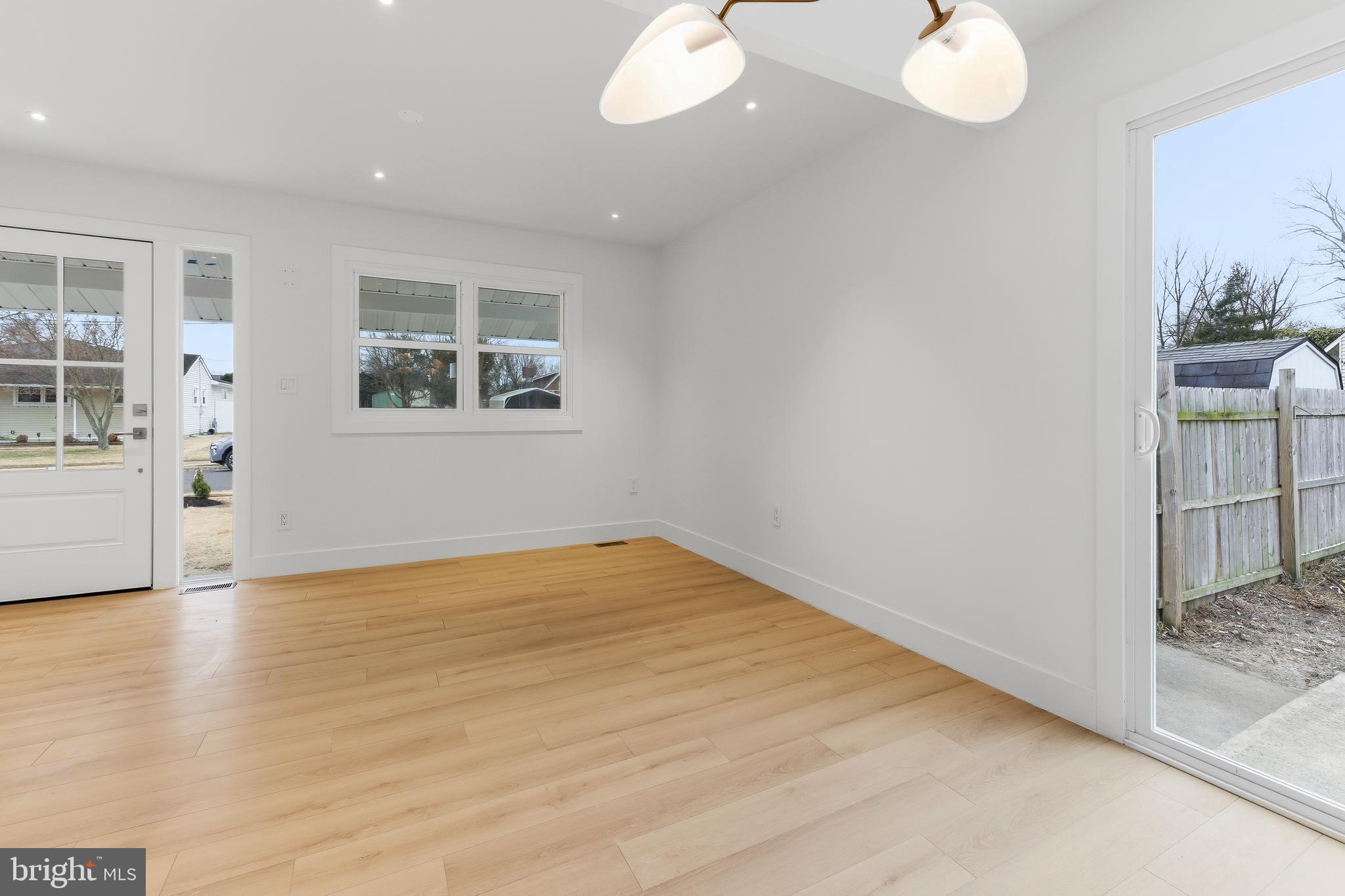 68 Craig Drive Deptford, NJ 08096 - Photo 7 of 20 an empty room with wooden floor and windows