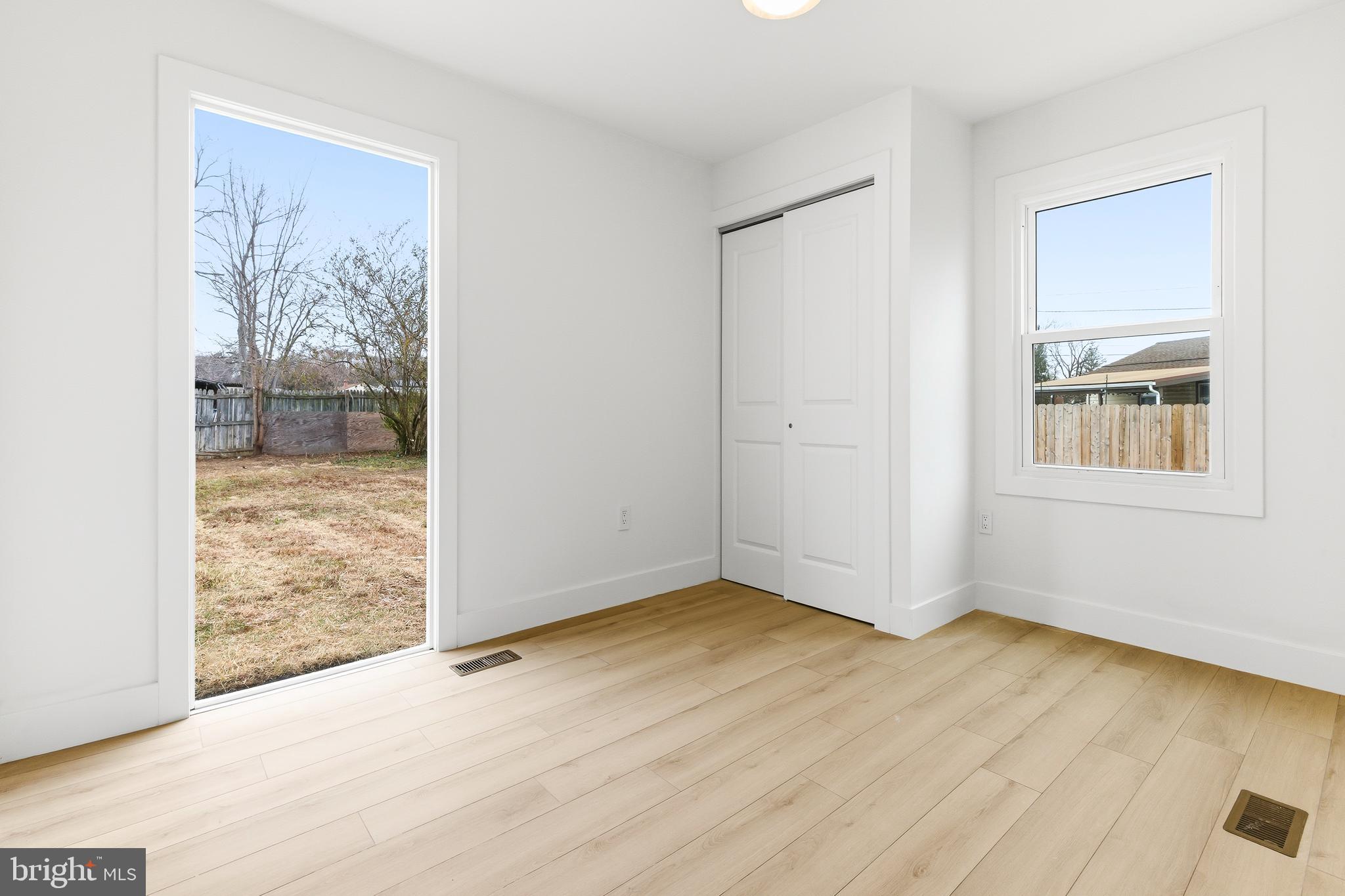 68 Craig Drive Deptford, NJ 08096 - Photo 8 of 20 an empty room with wooden floor and windows