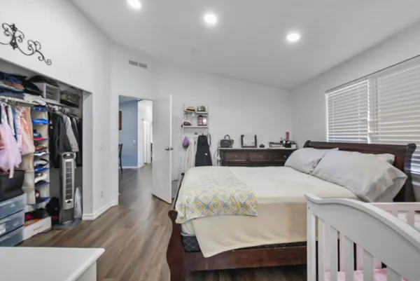 a bedroom with a bed and a flat screen tv