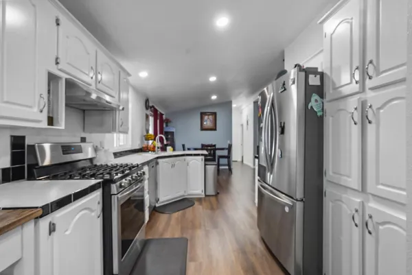 a kitchen with stainless steel appliances a stove sink and refrigerator