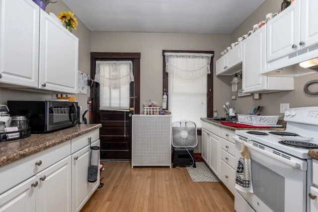 a kitchen with a sink stove and cabinets