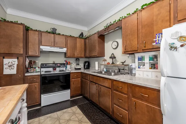 a kitchen with stainless steel appliances granite countertop a sink and cabinets