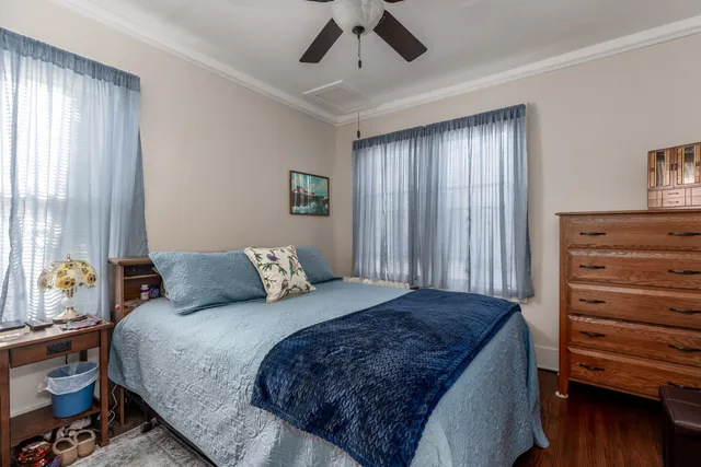 a large bed sitting in a bedroom next to a window