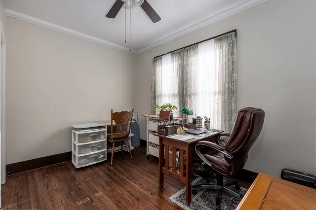 a view of a workspace with furniture and a window