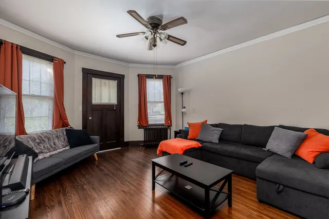 a living room with furniture and wooden floor