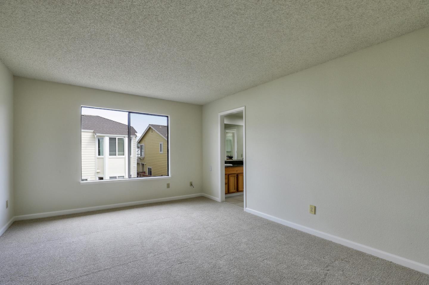 271 Michigan Road Milpitas, CA 95035 - Photo 25 of 34 an empty room with a window and a kitchen