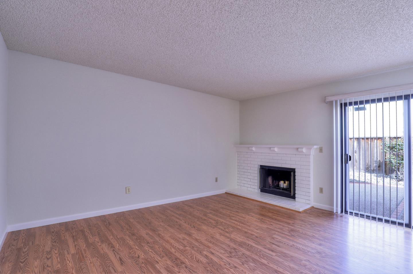 271 Michigan Road Milpitas, CA 95035 - Photo 9 of 34 a view of an empty room with wooden floor fireplace and a window