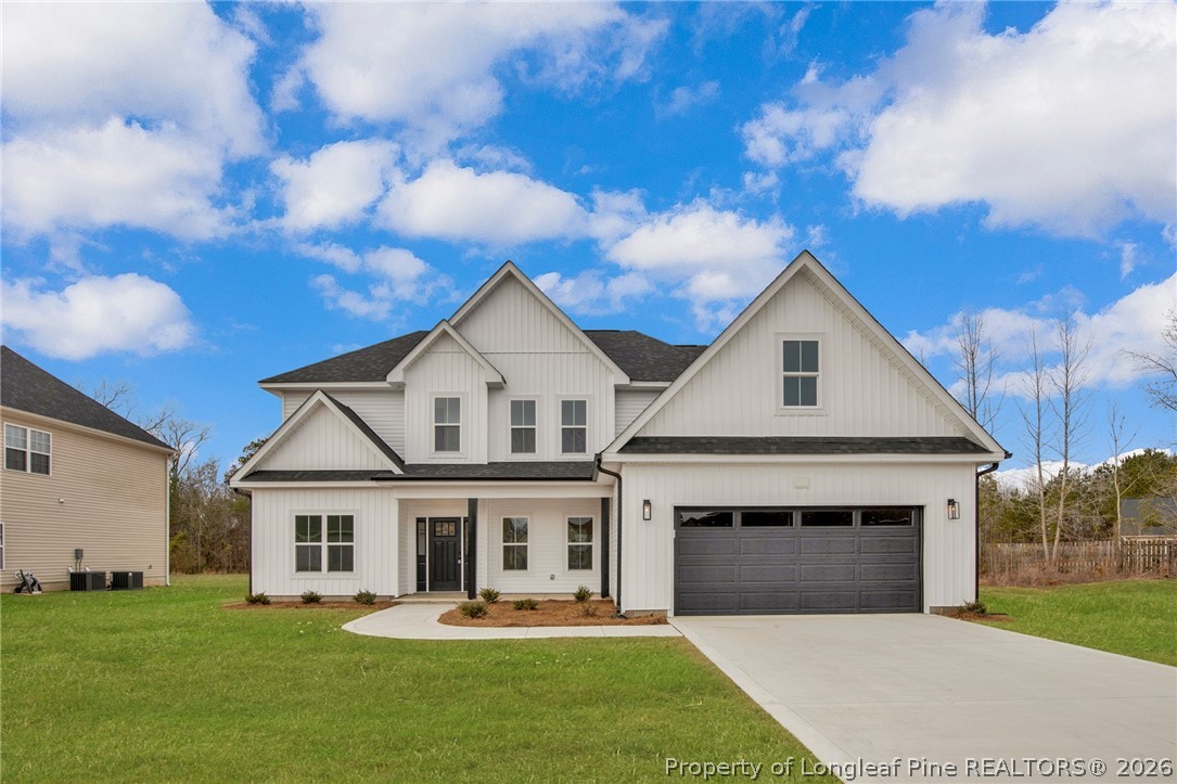 116 Surveyor Street Raeford, NC 28376 - Photo 1 of 45 a front view of a house with a yard and garage
