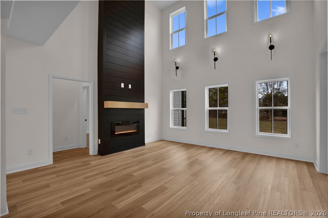 116 Surveyor Street Raeford, NC 28376 - Photo 11 of 45 a view of an empty room with wooden floor and a window