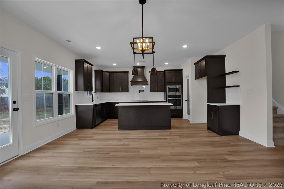 116 Surveyor Street Raeford, NC 28376 - Photo 13 of 45 a view of kitchen with sink refrigerator and wooden floor