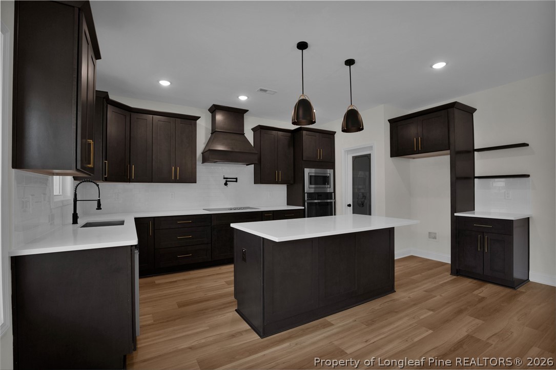 116 Surveyor Street Raeford, NC 28376 - Photo 15 of 45 a kitchen with stainless steel appliances granite countertop a sink a stove and a refrigerator