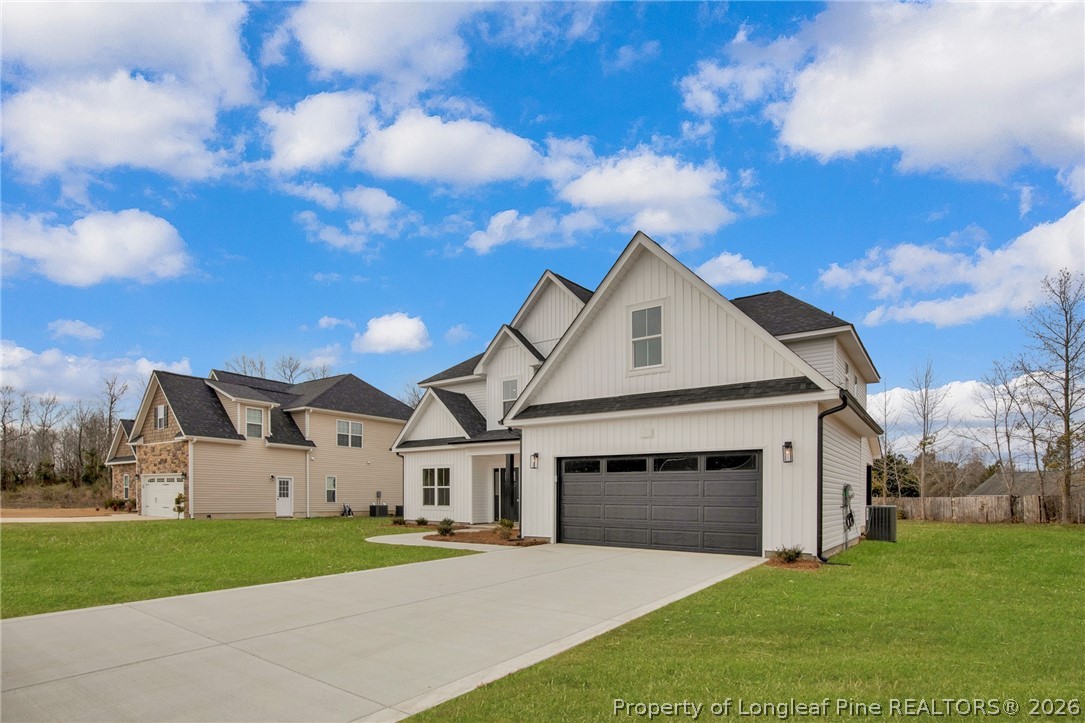116 Surveyor Street Raeford, NC 28376 - Photo 2 of 45 a front view of a house with a yard and garage