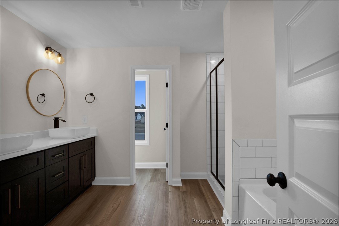 116 Surveyor Street Raeford, NC 28376 - Photo 38 of 45 a spacious bathroom with a sink and a mirror