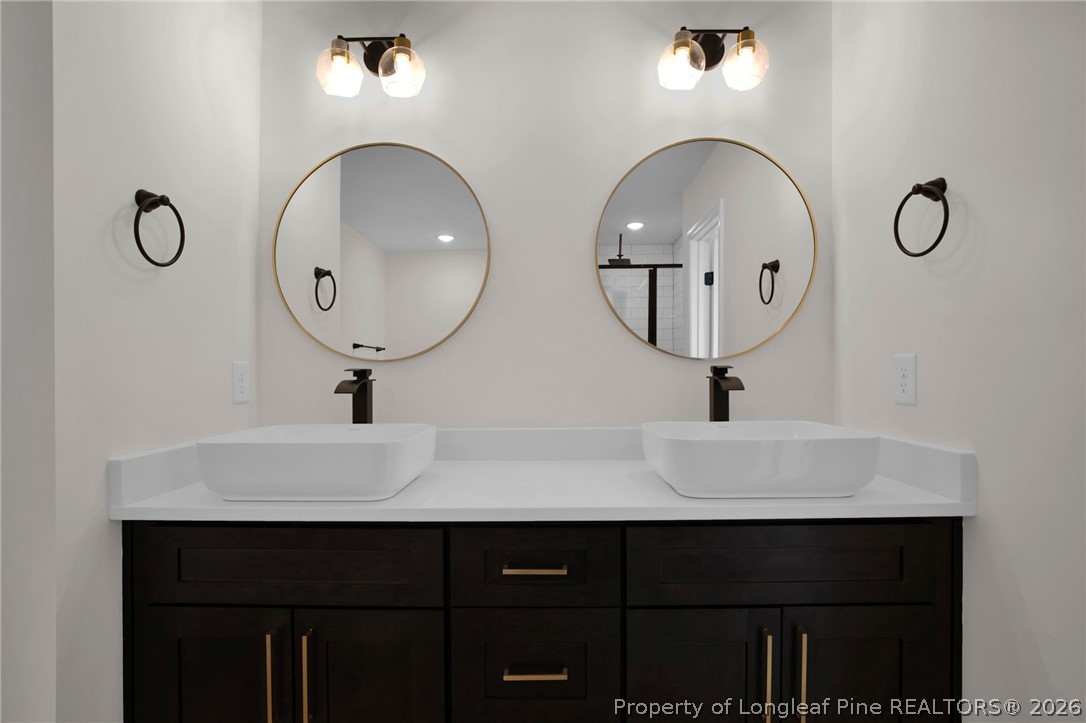 116 Surveyor Street Raeford, NC 28376 - Photo 39 of 45 a bathroom with a double vanity sink and a mirror