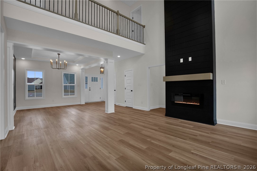 116 Surveyor Street Raeford, NC 28376 - Photo 7 of 45 a view of an empty room with wooden floor and a kitchen