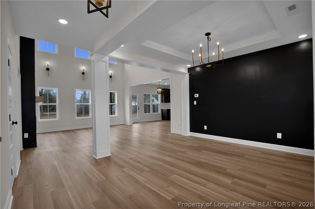 116 Surveyor Street Raeford, NC 28376 - Photo 10 of 45 an empty room with wooden floor and windows