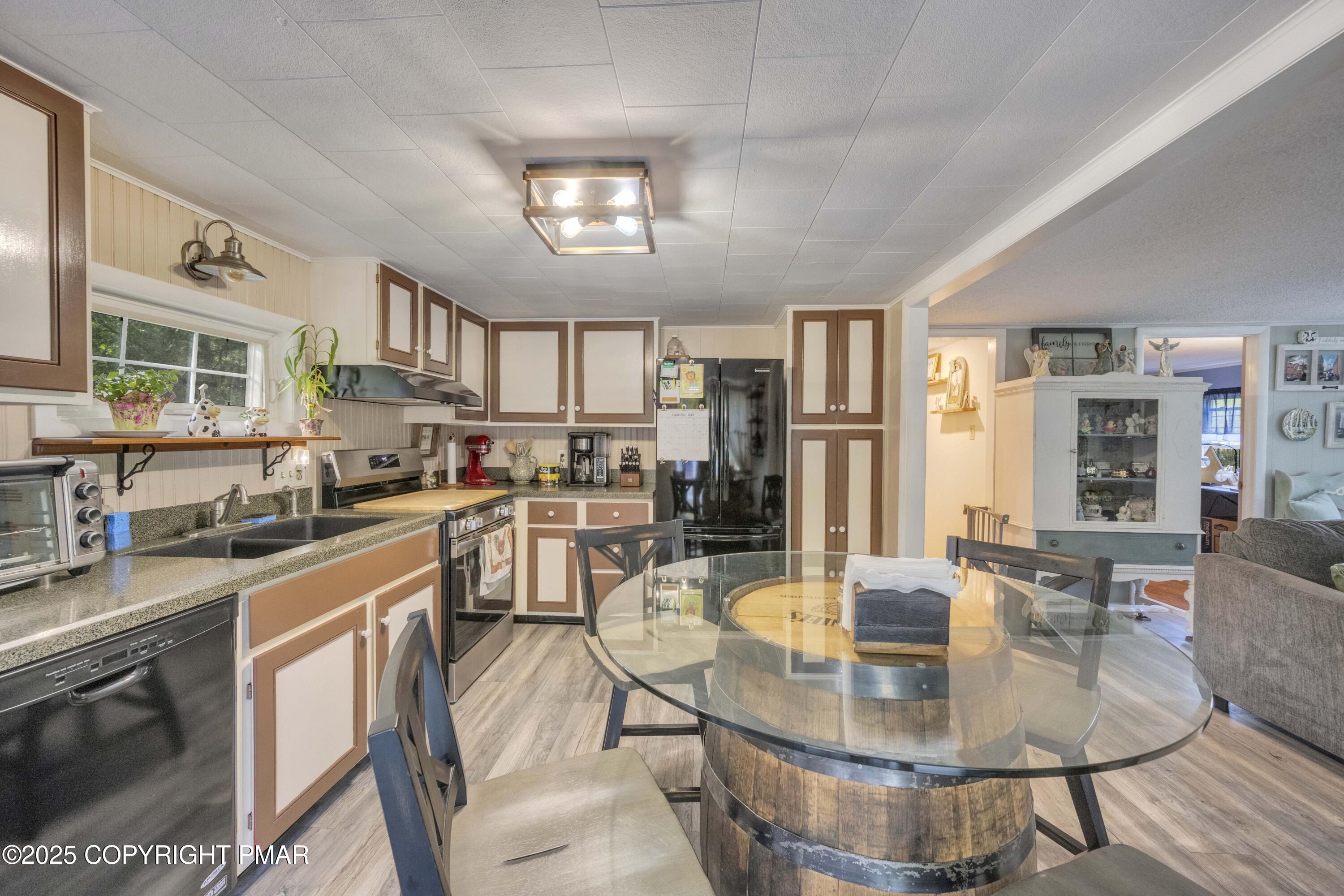 117 Streamside Street Kunkletown, PA 18058 - Photo 22 of 37 a kitchen with stainless steel appliances granite countertop a stove a sink a dining table and chairs