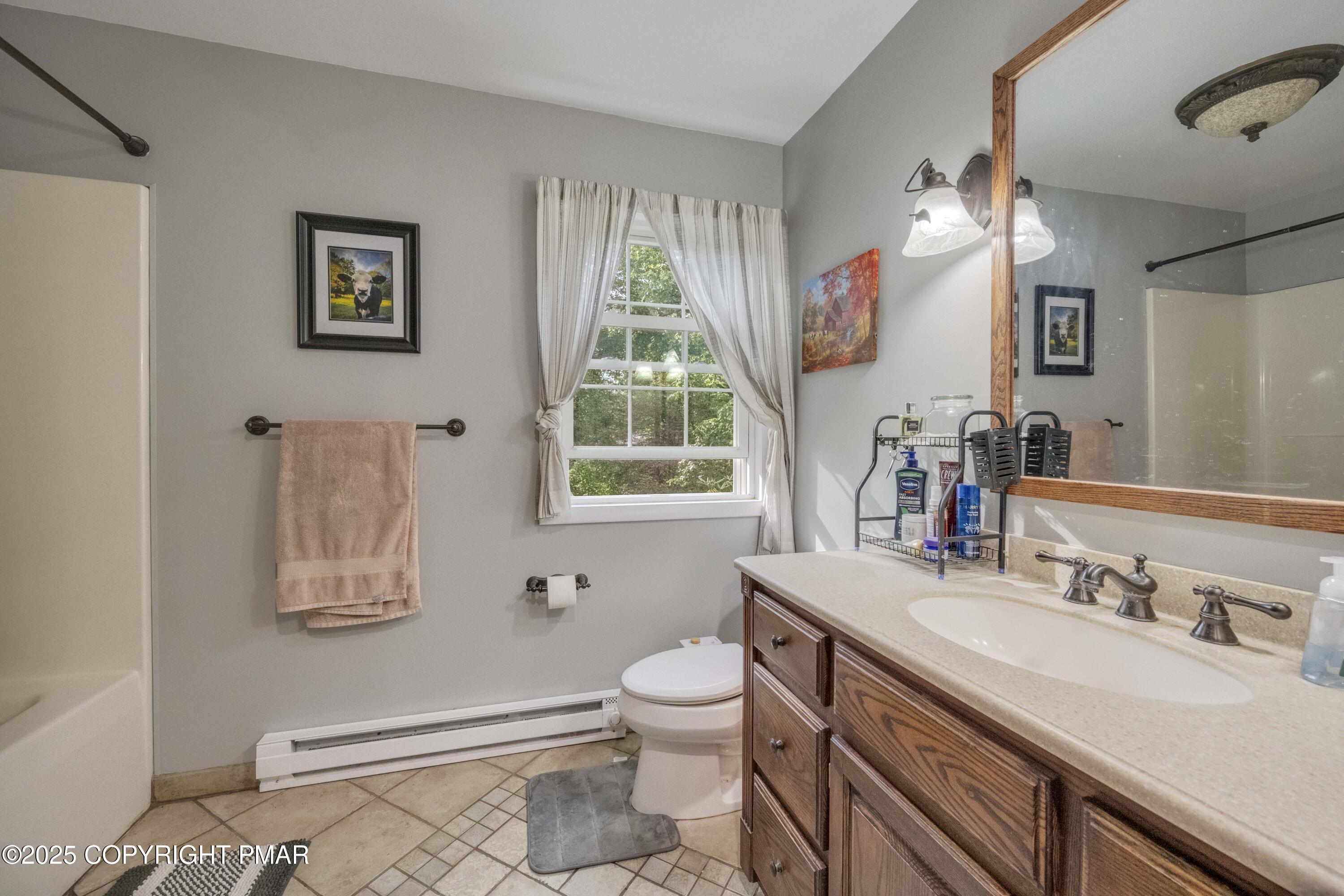 117 Streamside Street Kunkletown, PA 18058 - Photo 33 of 37 a bathroom with a granite countertop sink a toilet and a mirror