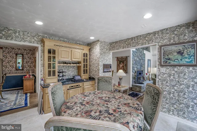 a bedroom with a bed and large windows