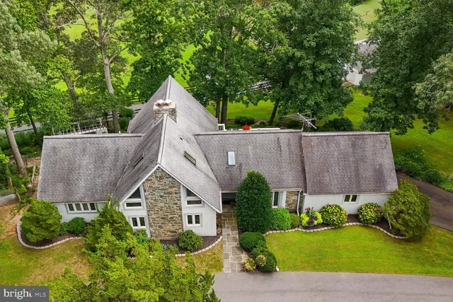 an aerial view of a house with garden and plants