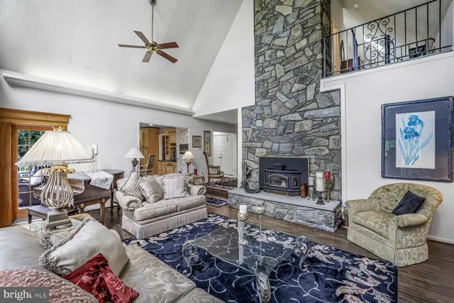 a living room with furniture a fireplace and a large window