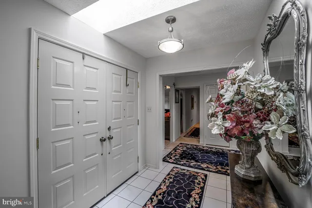 a room with lot of flowers and cabinets