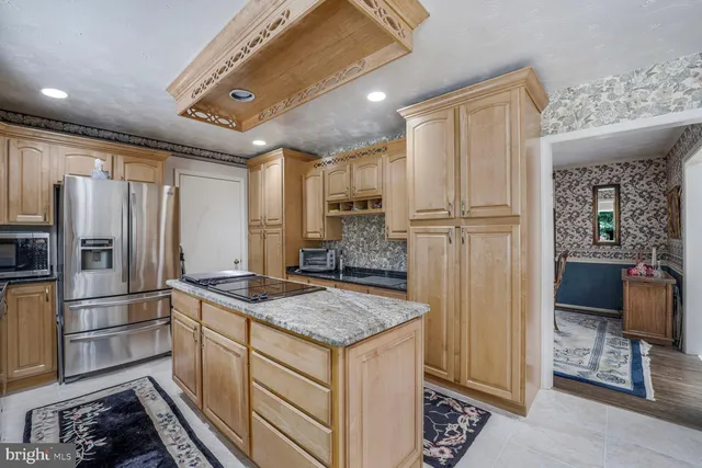 a spacious bedroom with a bed mirror and window