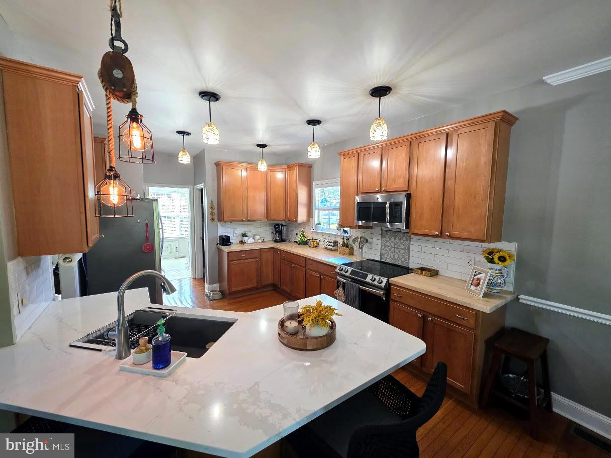 8 Elk Lane Elkton, MD 21921 - Photo 3 of 19 a kitchen with a sink a stove and chairs