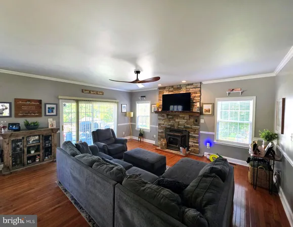 a living room with fireplace furniture and a flat screen tv