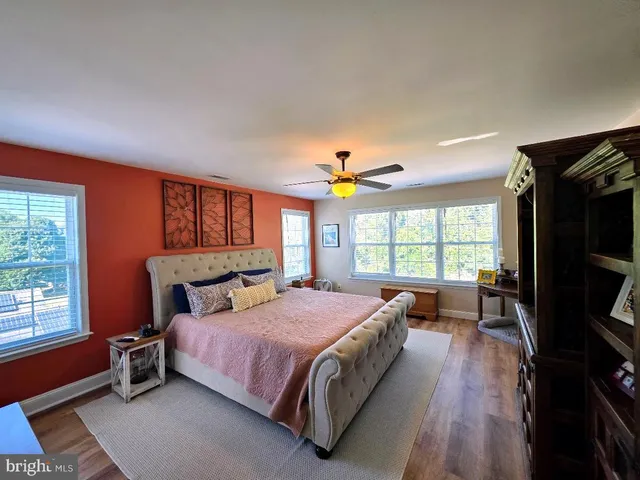 a bedroom with a bed and a large window