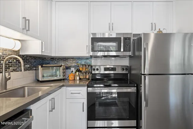 a kitchen with stainless steel appliances a refrigerator stove and sink