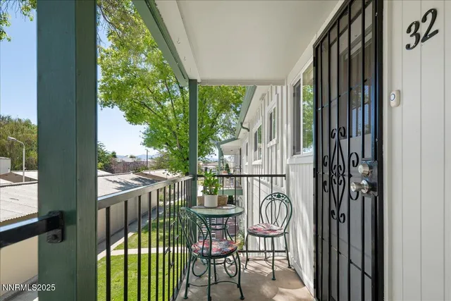 a balcony with table and chairs
