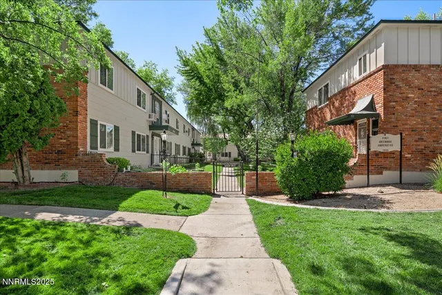 a front view of a house with a yard and plants