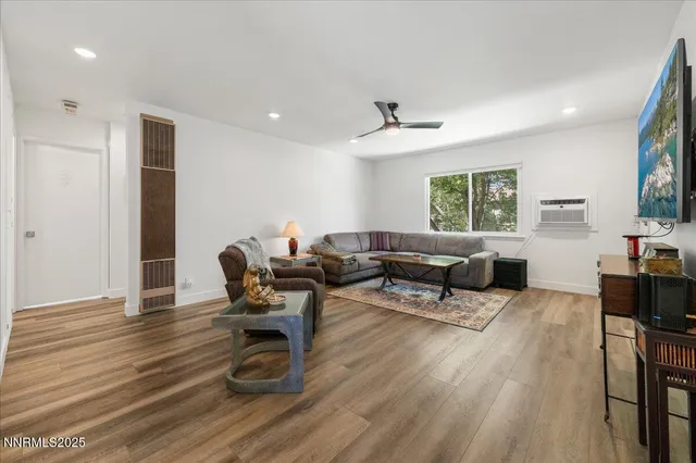 a living room with furniture and a wooden floor