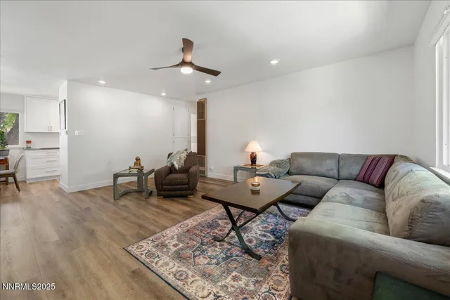 a living room with furniture and a wooden floor