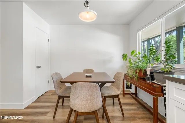 a view of a dining room with furniture window and wooden floor